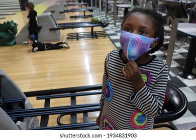 Elmont, New York  United States - March 7 2021: Kids Wearing Face Masks At Bowling Alley During Coronavirus Pandemic