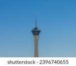 Elongated Stratosphere Tower in Las Vegas rises against a clear blue sky, its modern architecture and observation deck promising breathtaking city views.