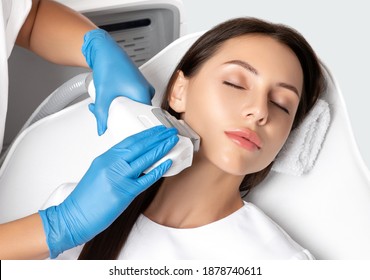 Elos epilation hair removal procedure on the face of a woman. Beautician doing laser rejuvenation on the neck in a beauty salon. Facial skin care. Hardware ipl cosmetology - Shutterstock ID 1878740611
