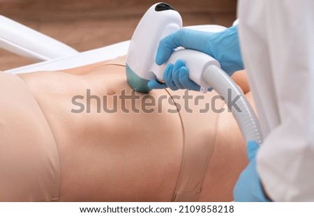 Elos epilation hair removal procedure on a woman’s body. Beautician doing laser rejuvenation on the lower leg in a beauty salon. Removing unwanted body hair. Hardware ipl cosmetology