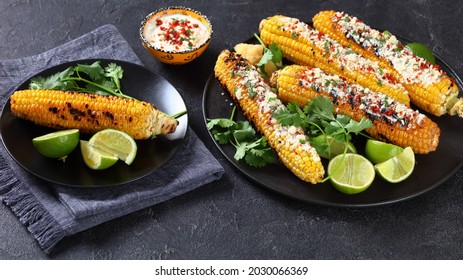 Elote, Grilled Mexican Street Corn, charred cobs are slathered in sour cream based sauce, seasoned with chili powder and sprinkled with cheese, cilantro
