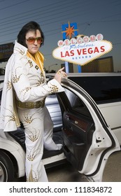 Elvis Impersonator In Front Of A 'Welcome To Las Vegas' Sign