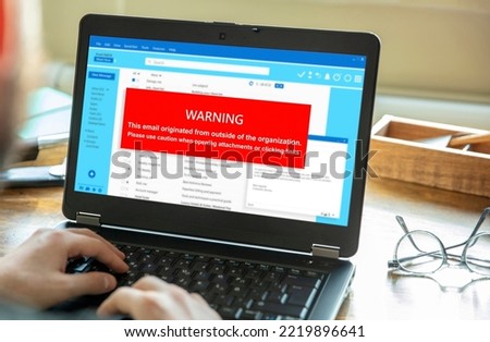 Email attachments warning message on a laptop screen. Computer Virus and Antivirus. Cyber security concept.