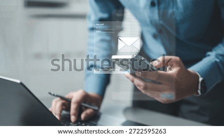 email, compose, template, e-mail, A person composing an email on a smartphone while working on a laptop, representing digital communication, messaging workflow, and online correspondence.