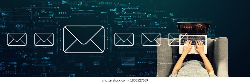 Email concept with person using a laptop in a chair - Shutterstock ID 1803527689