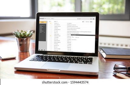 Email Inbox Message List On A Computer Laptop Screen, Office Wood Desk, Business Background. E-mail Correspondence Mail Concept