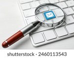 Email. Light blue button with illustration of envelope on computer keyboard, view through magnifying glass, closeup