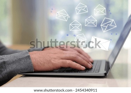 Email. Man using laptop at table, closeup. Letter illustrations over device