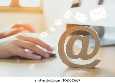 Email marketing concept, Hand using computer sending message with wooden email address symbol and envelope icon - Shutterstock ID 1065065627