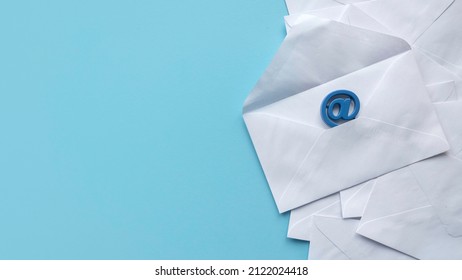 Email Marketing Concept. An Open White Envelope And Email Address Symbol On Blue Background With Copy Space.