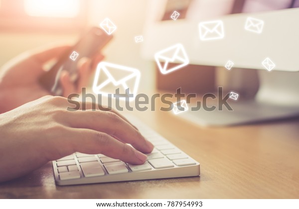 Email marketing and\
newsletter concept, Hand of man sending message and mobile phone\
with email icon