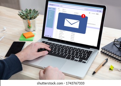 Email Notification Concept, Man Working With A Computer Laptop, One New Inbox E Mail Message On The Screen, Business Office Desk Background

