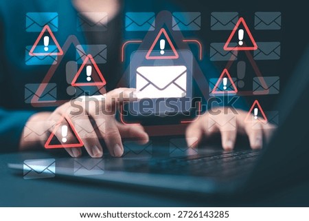 Email security software detecting phishing or scam emails with warning alerts, as a businessperson touches the email icon to delete malicious messages and protect sensitive data.
