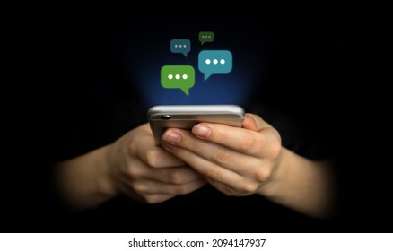 E-mail and social media. Hands using smartphone with new messages icon. Business and marketing concept, black background - Shutterstock ID 2094147937