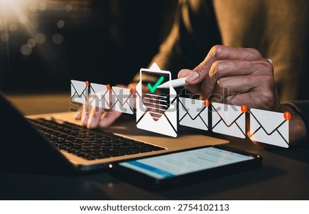 Email verification concept. Person using laptop and checking incoming messages with inbox icons representing email management, notification control, secure communication and digital business workflow