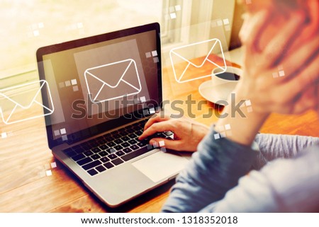 Emails with man using a laptop computer