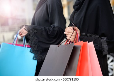 Emarati Arab women coming out of shopping in Dubai, United Arab Emirates.