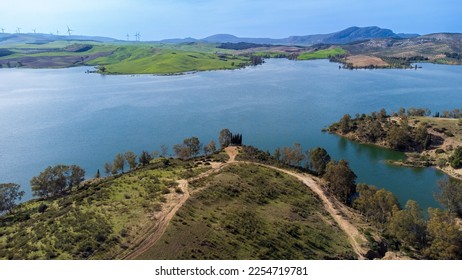 Embalse del Conde de Guadalhorce reservoir, manmade lake in a nature park with panoramic mountains and forest. Malaga province, Andalusia, Spain.