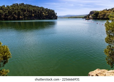 Embalse del Conde de Guadalhorce reservoir, manmade lake in a nature park with panoramic mountains and forest. Parque Natural de Ardales, Malaga province, Andalusia, Spain.