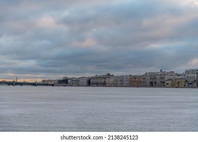 Embankment Of Neva River At Sunrise In Saint Petersburg City, Russia. Cloudy Sky. River Surface Covered With Ice. No People. Travel In Russia Theme.