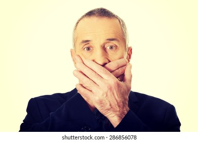 Embarassed Businessman Covering Mouth With Hands. 