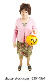 Embarassed Father Dressed Up As A Woman On Halloween, Carrying A Pumpkin Bucket Of Candy.  Full Body Isolated On White.