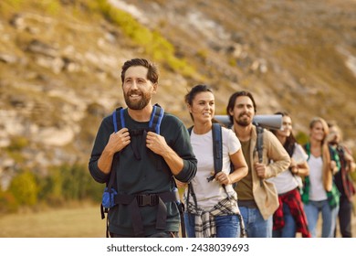 Embark on a mountain adventure with this group of friends. As a cohesive team of hikers and tourists, explore the majestic peaks, creating unforgettable memories during exciting vacation trip. - Powered by Shutterstock