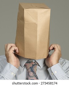 Embarrassed Businessman Pulls A Brown Paper Bag Over His Head.