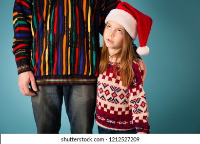 Embarrassed Christmas Girl In Ugly Sweater With Dad