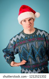 Embarrassed Christmas Guy In Ugly Sweater And Santa Hat