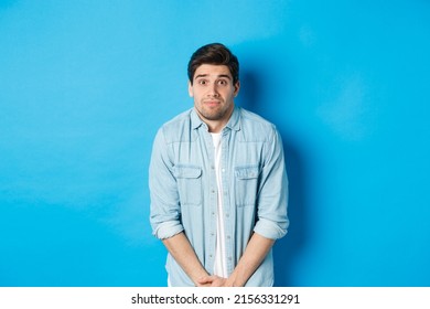 Embarrassed Guy Want To Pee, Waiting In Line For Toilet, Standing Against Blue Background