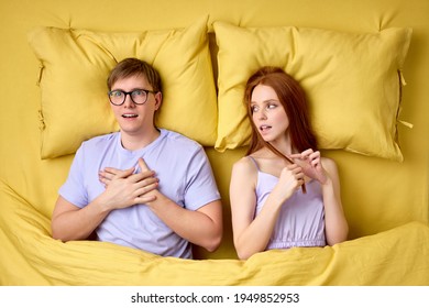 Embarrassed And Shy Caucasian Man Lying On Bed With Experienced Excited Female Before His First Intimacy In Bed