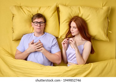 Embarrassed And Shy Man Lying On Bed With Experienced Excited Female Before His First Intimacy In Bed, Inexperience