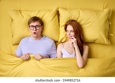 Embarrassed And Shy Man In Shock Lying On Bed With Experienced Excited Female Before His First Intimacy In Bed