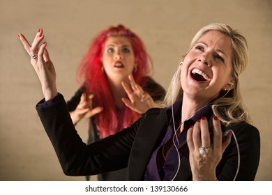 Embarrassed Teen In Pink Hair With Singing Parent Holding Mp3 Device