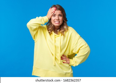 Embarrassed And Worried Girl Bumped Into Car, Feel Anxious And Concerned, Touch Head Troubled, Grimacing With Awkward Grin, Face Problematic Situation, Stand Blue Background