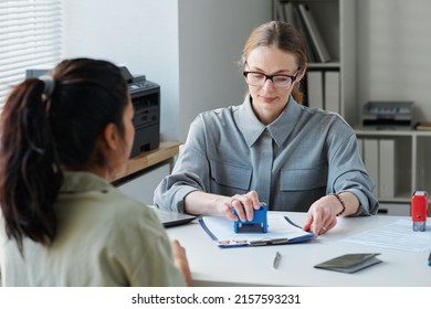 Embassy Worker Approving Visa At Office - Shutterstock ID 2157593231