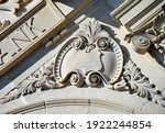 Embellished shield with swirling banner are part of the architecture on the Ruston State Bank in Ruston, Louisiana.  Stone masonry facade make up this historic bank.