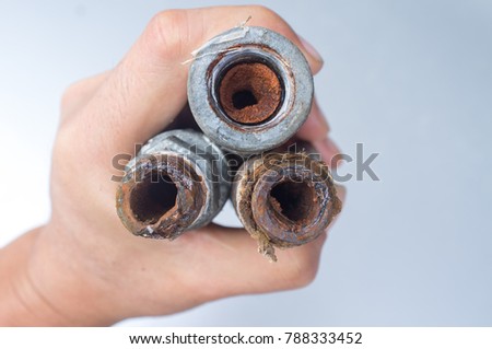 Embolism: A pipe clogged with sediment rust