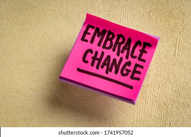 embrace change - handwriting on a  reminder note against textured paper, adaptation in business and personal development
