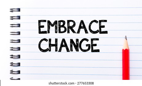Embrace Change Text written on notebook page, red pencil on the right. Motivational Concept image