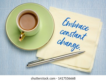Embrace constant change - handwriting on a napkin with a cup of coffe