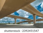 Embrace the dynamic urban landscape with this striking image featuring a prominent flyover or overpass. The elevated roadway creates a striking architectural silhouette against the cityscape