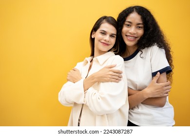 Embrace equity on multiracial Internal Women's Day. Lady diversity group good mood hands hug herself shoulders enjoy joyful soft cloth laundry warmth toothy smile.