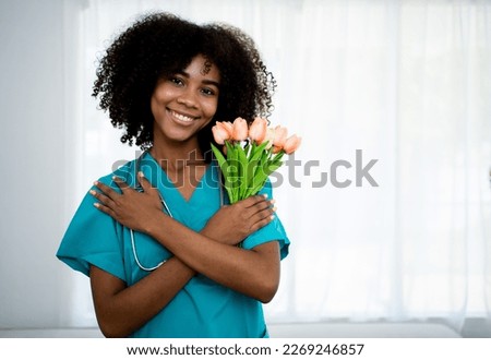 Embrace equity on multiracial Internal Women's Day. African lady with black hair good mood hands hug herself shoulders enjoy joyful warmth toothy smile.