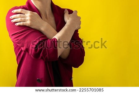 Embrace equity. Woman hug yourself dressed magenta jacket on yellow background. International women's day concept. Vivid colors, copy space Foto d'archivio © 