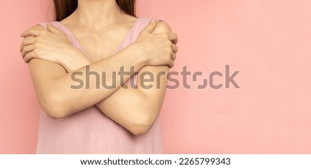 Embrace equity. Woman hug yourself dressed pastel pink dress on pink background. International women's day concept. Pastel colors, copy space