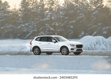 Winter’s embrace holds no barrier for this powerful SUV as it glides through the snowy terrain with grace and power showcasing man’s conquest over nature. White truck car on the winter snowy road. - Powered by Shutterstock