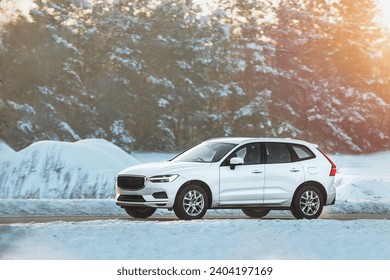 Winter’s embrace holds no barrier for this powerful SUV as it glides through the snowy terrain with grace and power showcasing man’s conquest over nature. White truck car on the winter snowy road. - Powered by Shutterstock