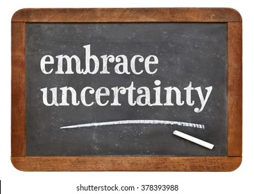 embrace uncertainty sign - white chalk text on a vintage slate blackboard